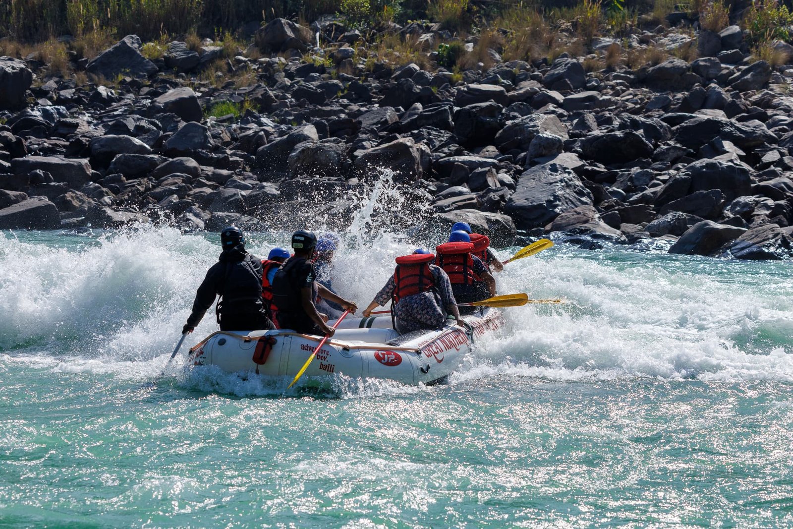 Raft crashing through a white water rapid on the Ganga near Rishikesh