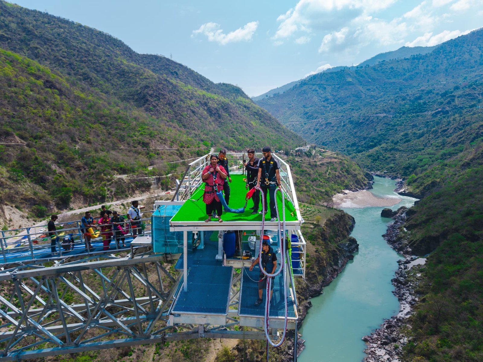 Instructors harnessing a guest on top of the Adventure Island bunjee platform