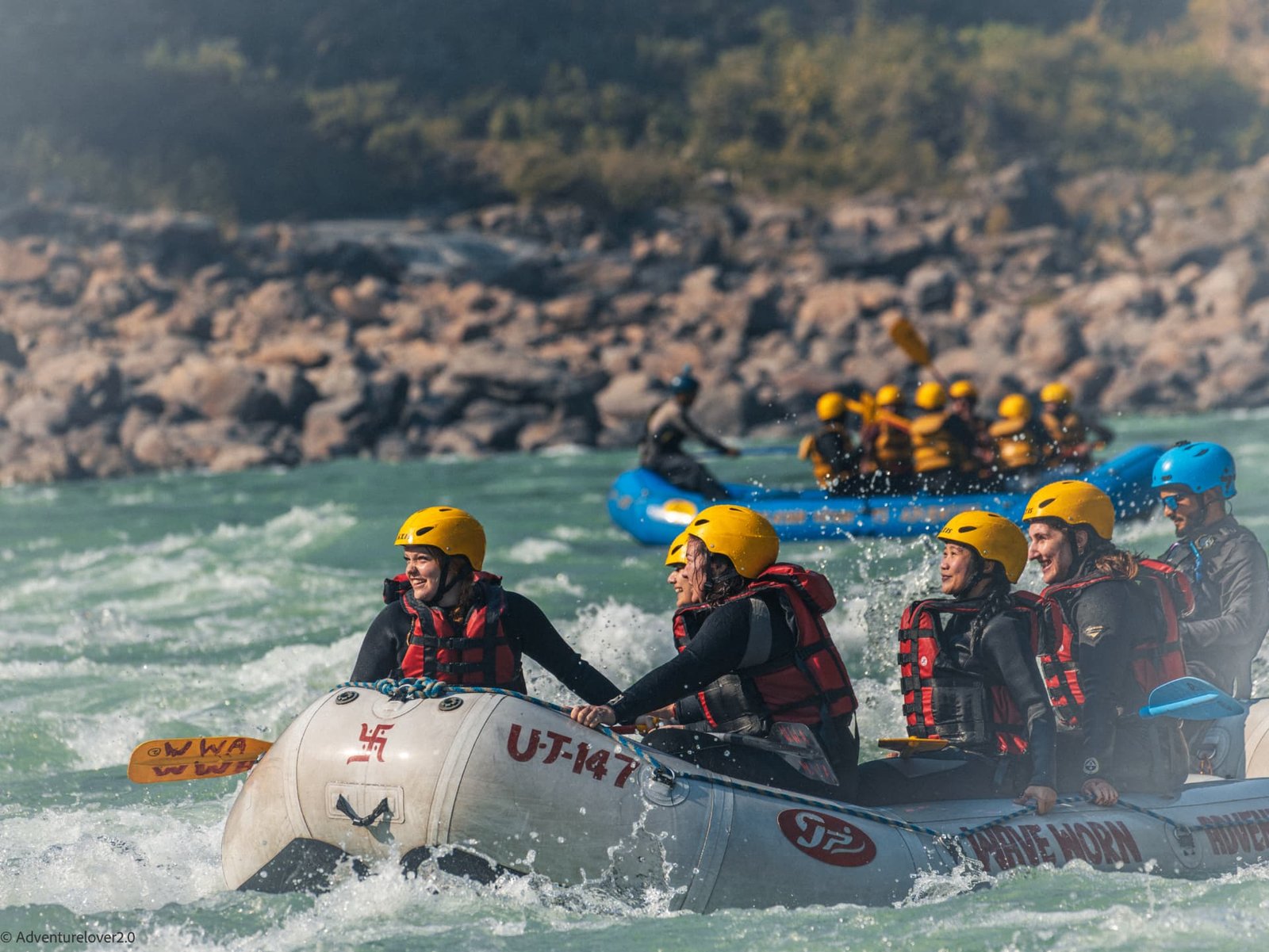 Rafting crew paddling through white water on the Ganga in Rishikesh