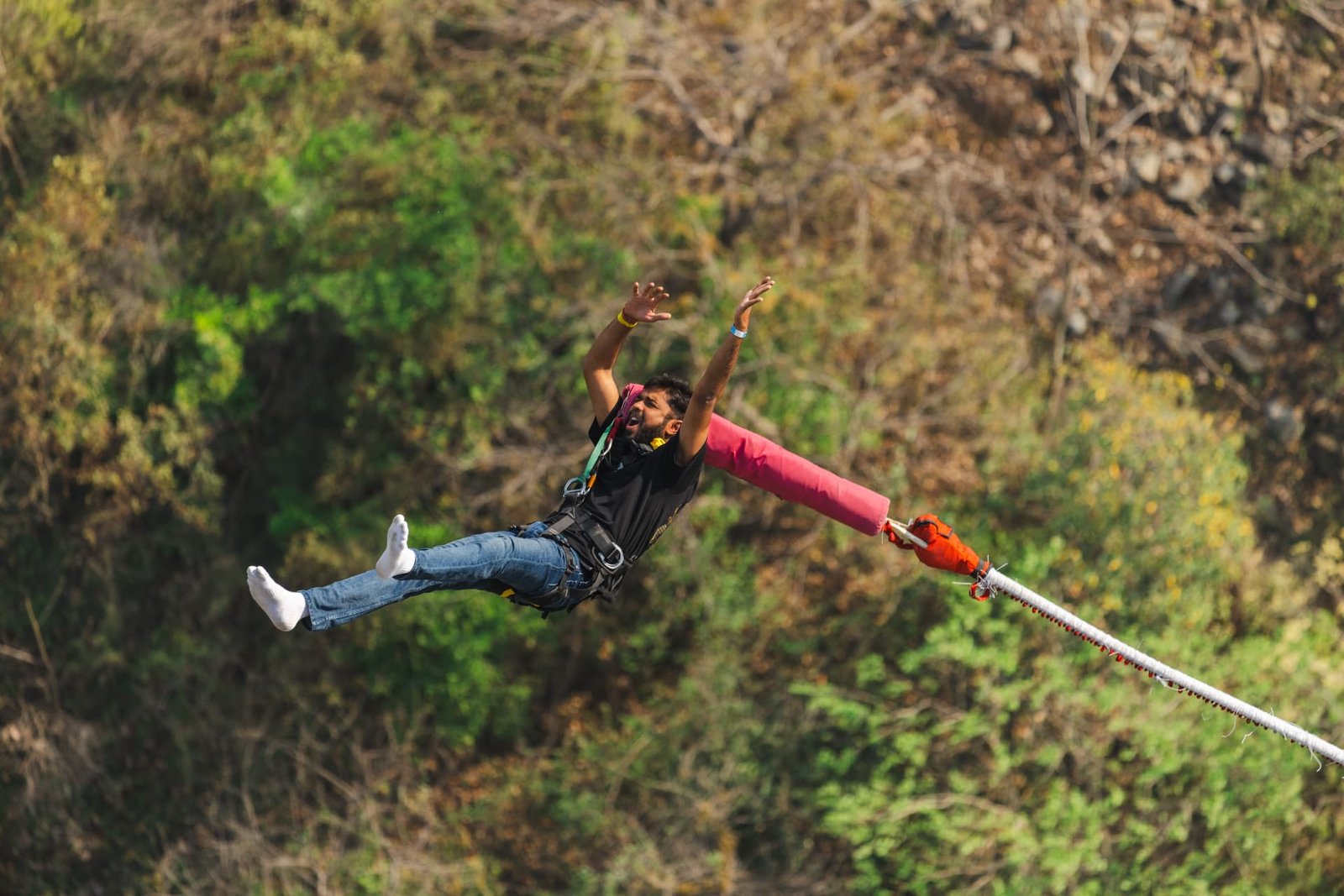Bunjee jumper in a starfish free fall from the 219M Maa Ganga Bunjee platform over the Ganga gorge in Rishikesh