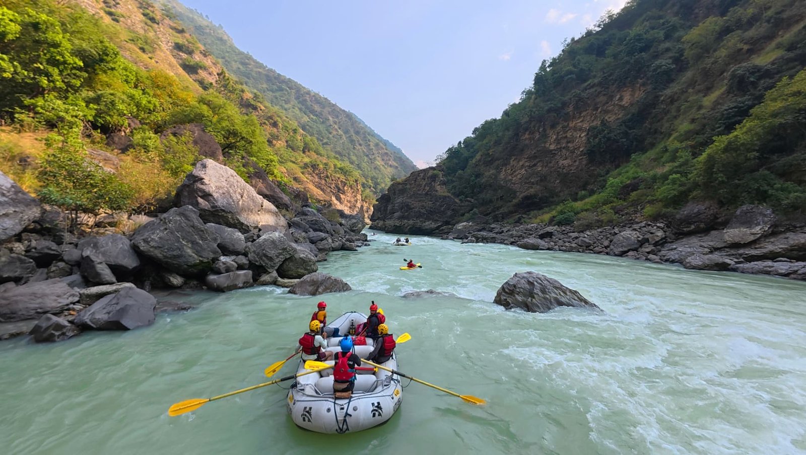 Aerial view of rafts moving down the Ganga through the Rishikesh valley